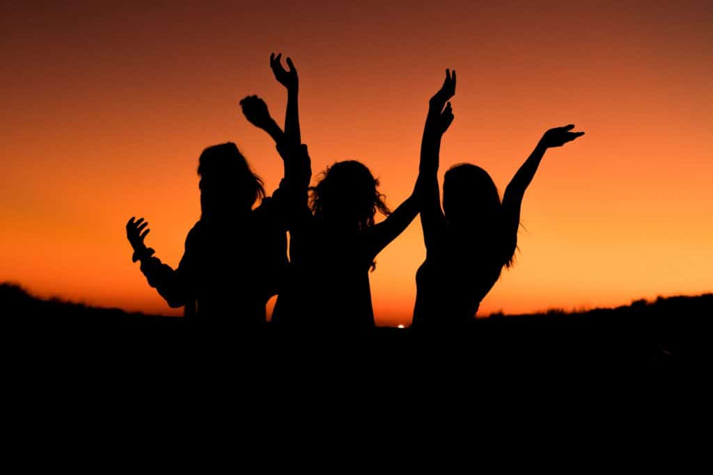 a silhouette photo of woman group of friends